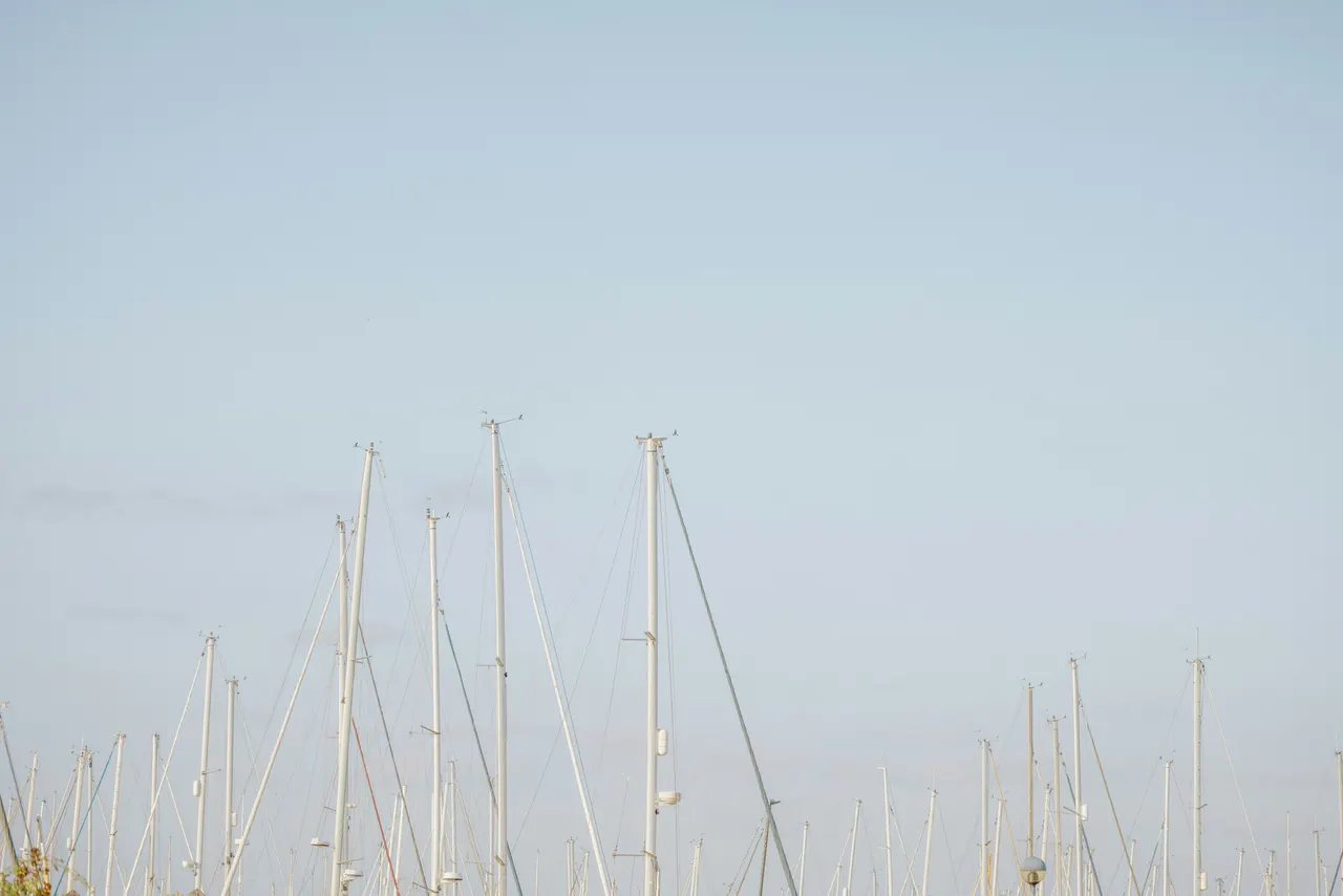 Pale marina scene with a soft atmospheric horizon.