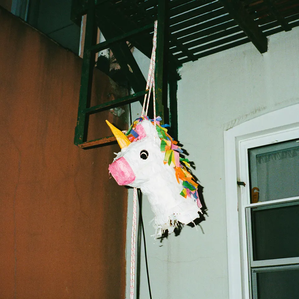 Pinata hanging near a stair and doorway.